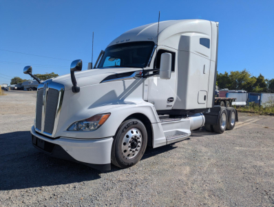 Kenworth T680 tractor in white, side view showing cab with sleeper, dual rear wheels, and front grille