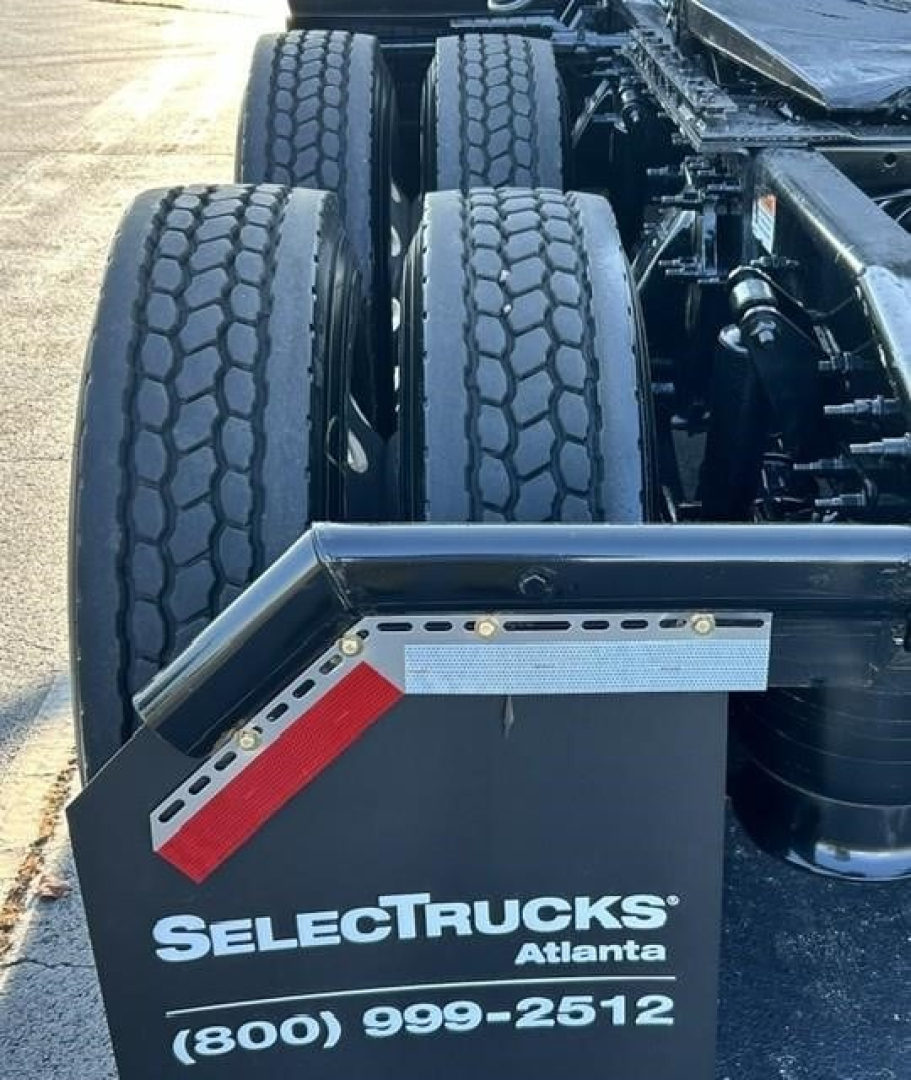 Freightliner Cascadia 126 tractor rear with dual rear axles and fifth wheel; SelectTrucks Atlanta plate with phone number.