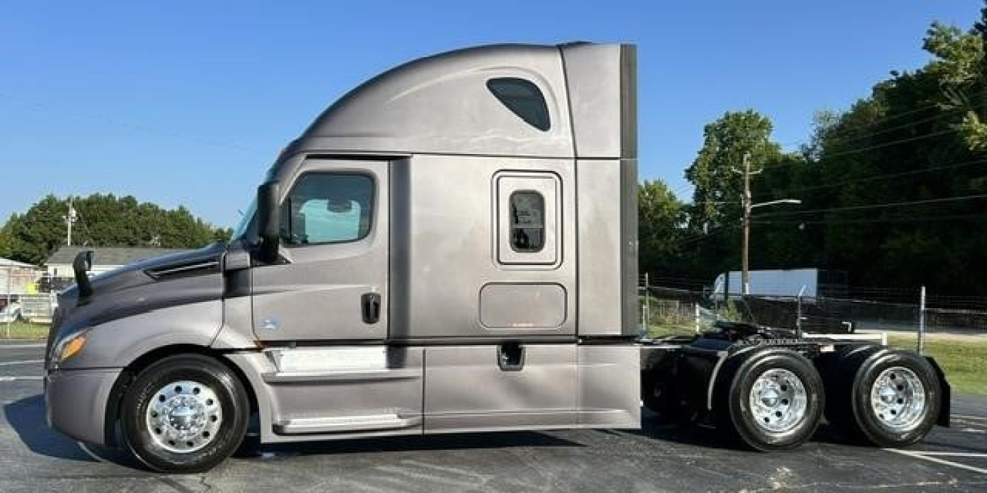 Freightliner Cascadia 126 sleeper cab truck side profile showing chrome wheels and triple rear axles.