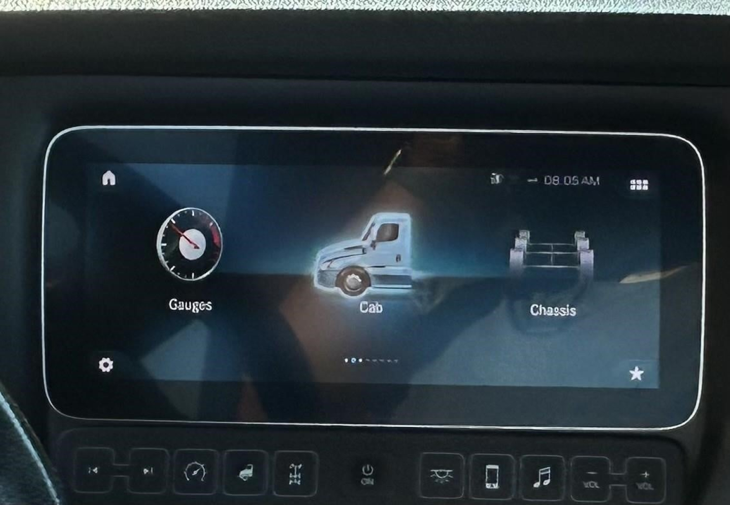 In-vehicle touchscreen display in a Freightliner Cascadia showing gauges, cab, and chassis icons.