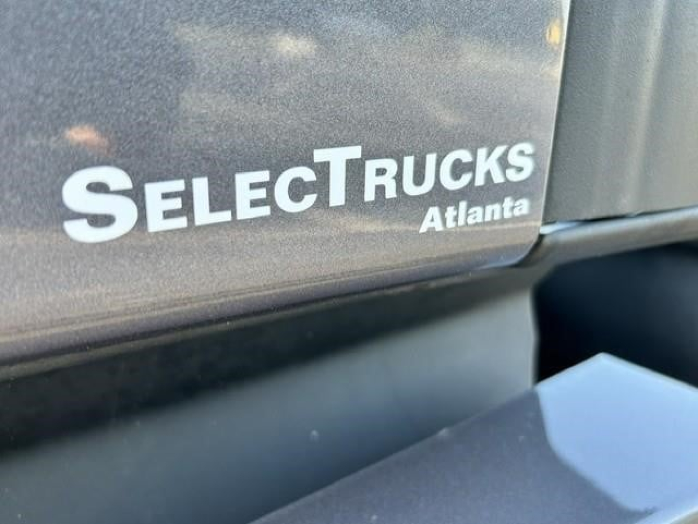 SelectTrucks Atlanta emblem on Freightliner Cascadia cab showing SelectTrucks branding.