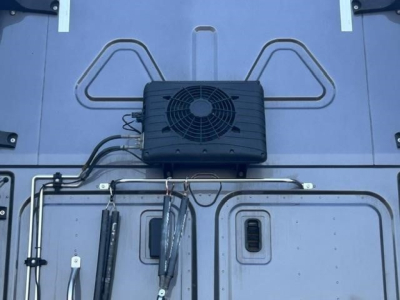 Freightliner Cascadia 126 cab area showing rooftop A/C condenser unit and associated tubing mounted on roof of trailer-style exterior panel.