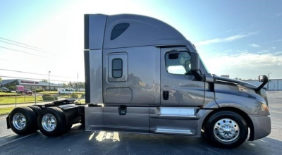 Freightliner Cascadia 126 side view with sleeper cab and dual rear axles, metallic gray paint and chrome wheels.
