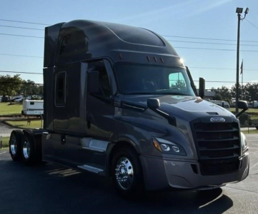 Freightliner Cascadia 126 tractor cab in view showing front grille and sleeper cab.