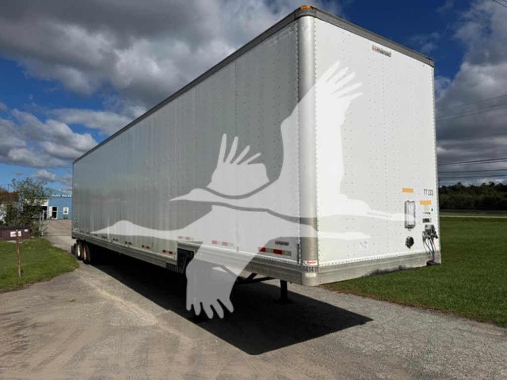 2015 Manac Drop Van trailer back-right view with white side, rear doors, and suspension visible.