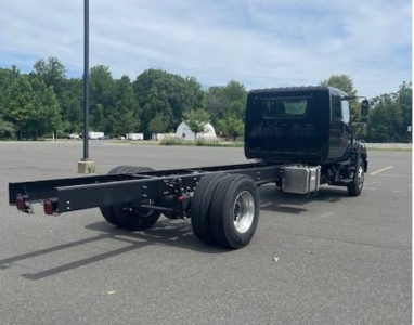 Front-right view of a new 2027 Hino L7 cab chassis truck with empty wheelbase, showing chassis frame and dual rear wheels.