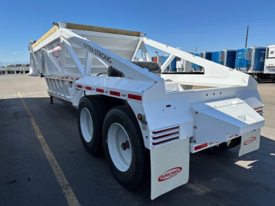 Dump trailer showing white Dura Haul air ride bottom dump with dual rear axles and hydraulic tailgate. Extrastraong label visible on side.