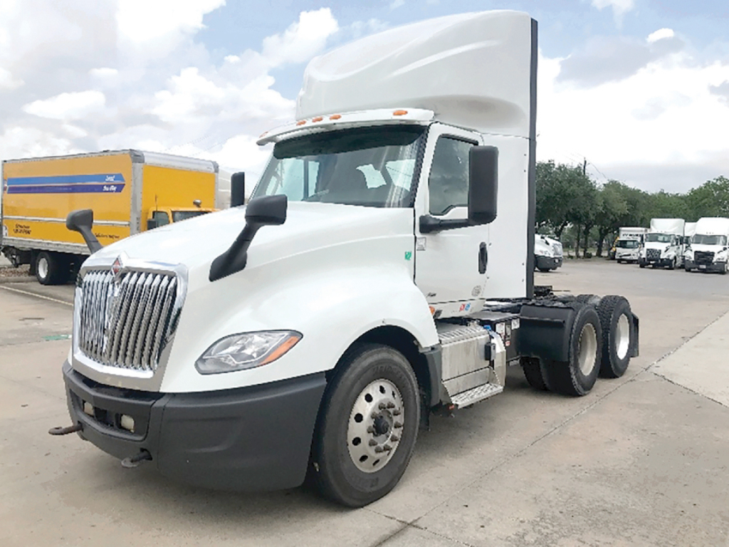 White 2018 International LT625 day cab tractor in a parking lot, front-left view, with sleeper cab and dual rear axles.