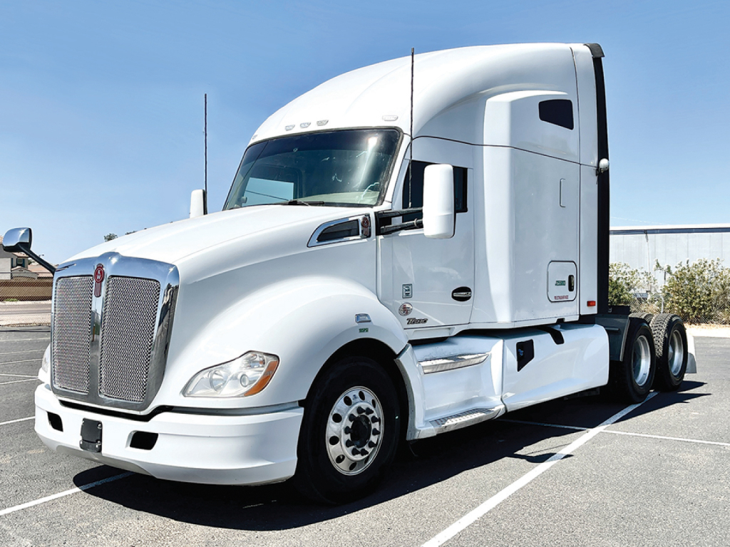 Kenworth T680 Conventional Sleeper truck in white, side view showing cab and front grille