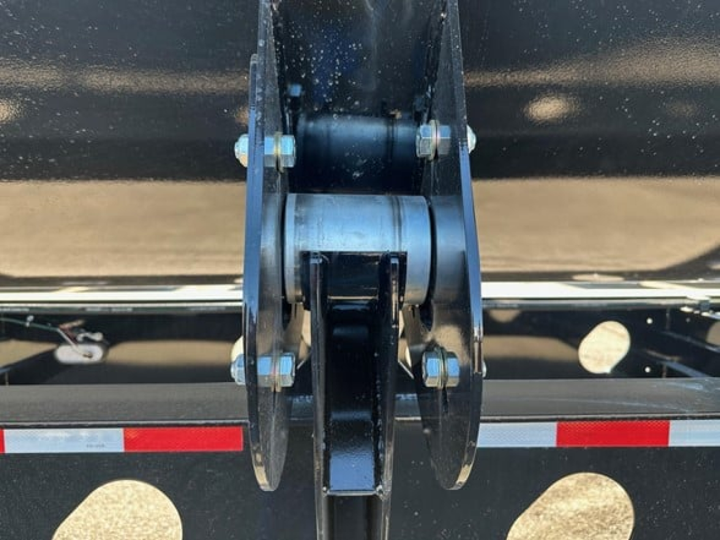 Front hinge of a 2026 Jet 40' air ride side dump trailer showing pin and clevis assemblies and mounting hardware.