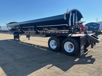 Trailer side dump showing Jet 40' air ride dump trailer with tandem axle, black body, rear hydraulics, and loading chute in reach-out position.