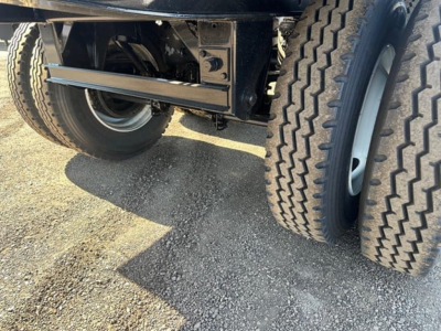 Semi-trailer underside and dual rear wheels of a 2026 Jet 40' Air Ride Side Dump showing dual tires and suspension components.