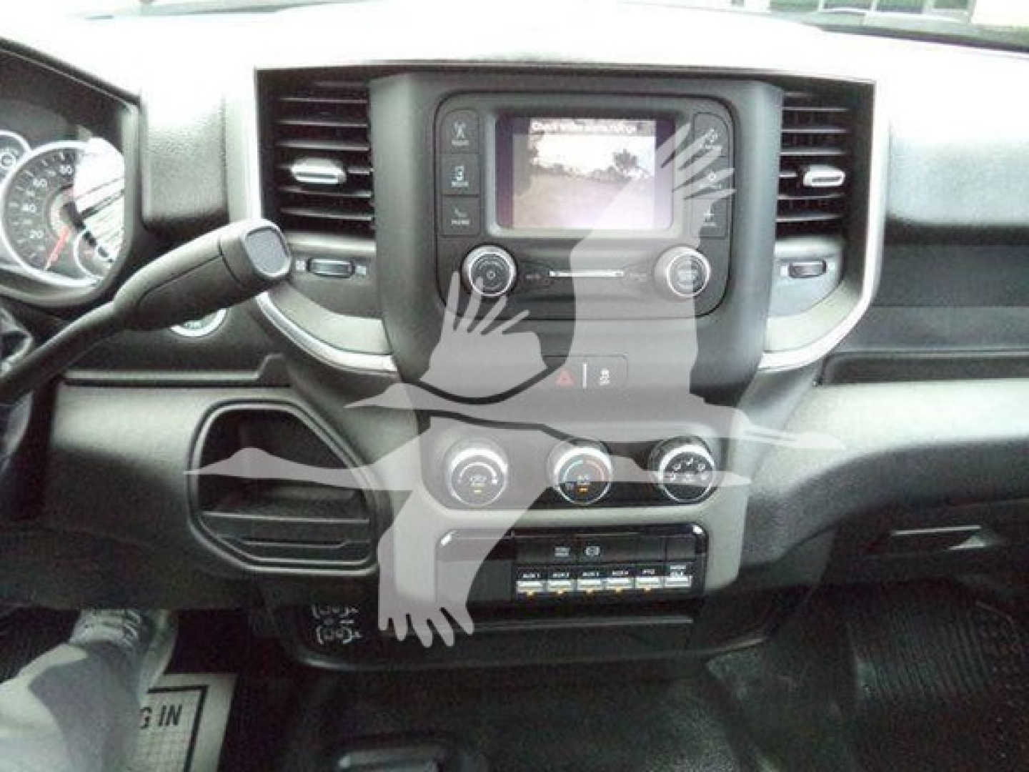 Ram truck interior center console with touchscreen display, climate controls, and gear shifter visible