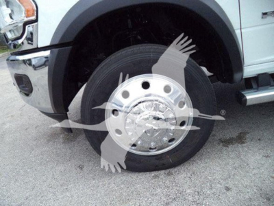 Wheel/front-left tire of a RAM 4500 with chrome hubcap, fender, and part of the bumper visible.