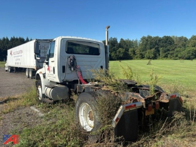 Tractor truck cab and chassis of a 2009 International DuraStar 4400 daycab with a trailer attached, visible rear view showing exhaust and mud flaps.