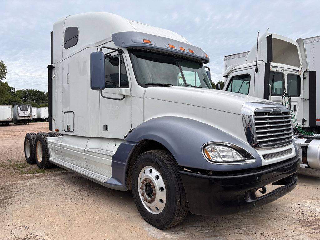 Truck cab showing Freightliner CL120 Columbia sleeper, front view with gray fenders and chrome grille.