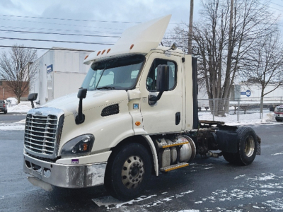 Freightliner Cascadia 113 cab and chassis in a neutral view showing front grille, bumper, headlights, and side steps.