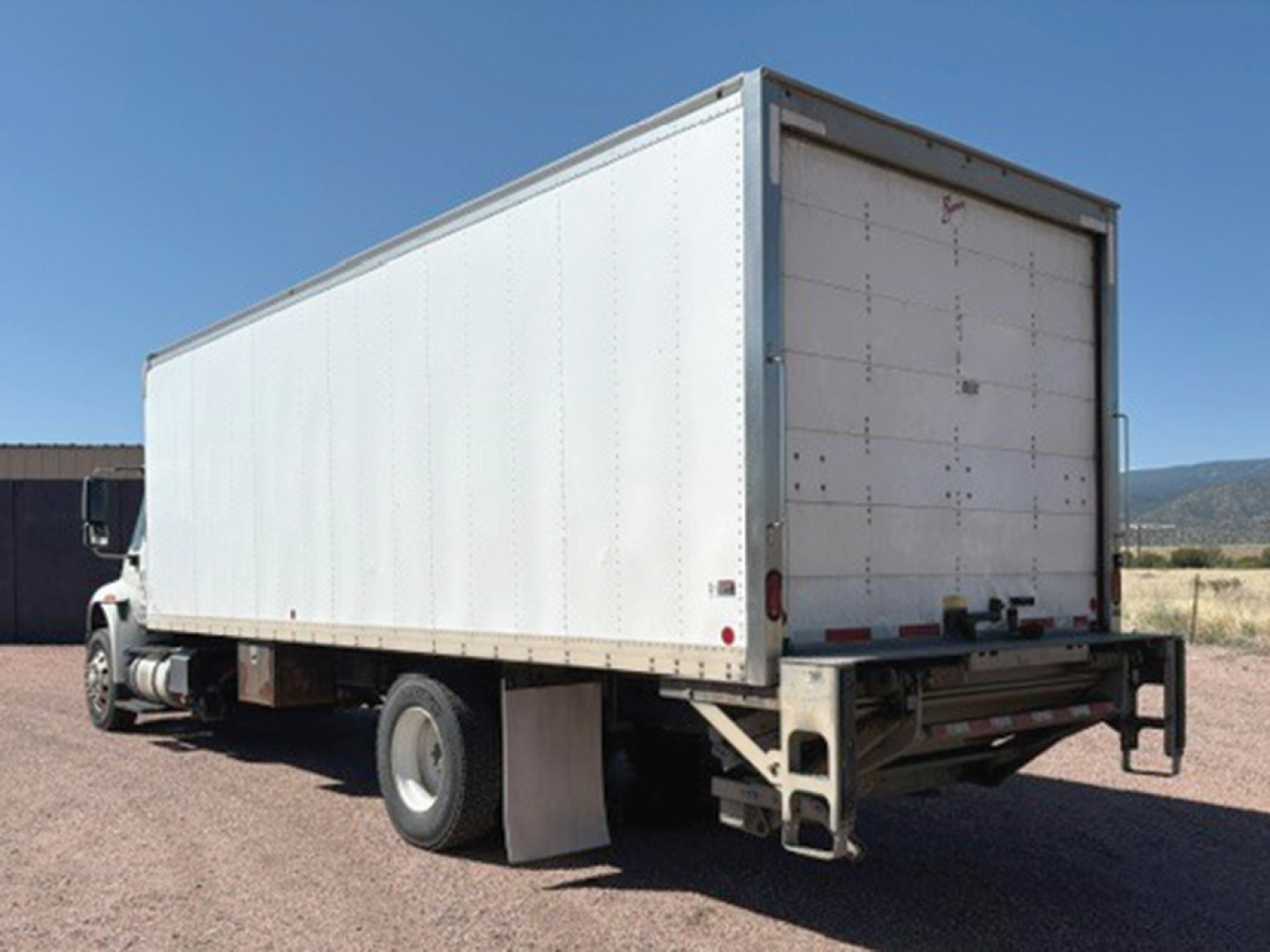 Truck trailer box and rear view of a 2019 International 4400 conventional daycab with box trailer.