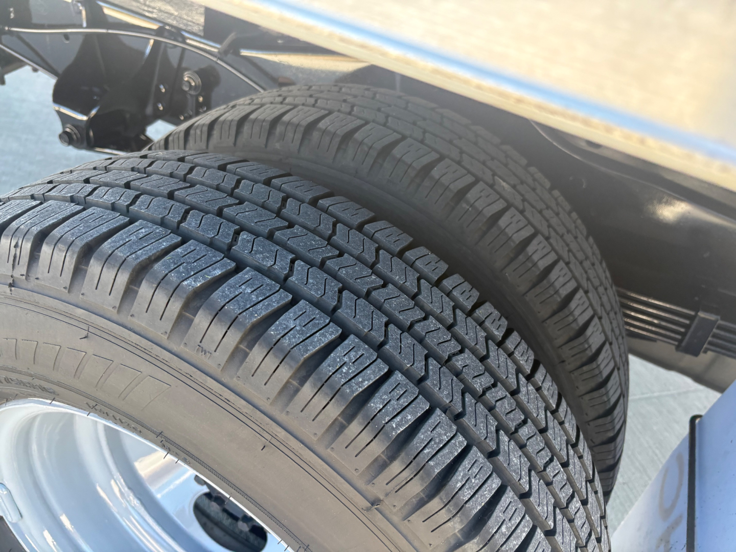 Ford E-350 box truck showing dual rear tires with tread pattern and wheel wells.