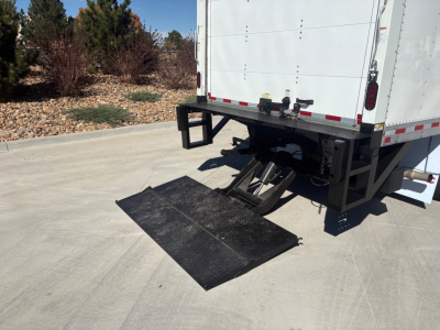 Ford E-350 box truck rear showing accessible hydraulic lift ramp and bumper with rear doors.