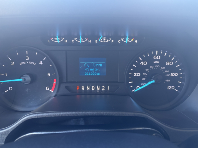 Dashboard view of a 2024 Ford E350 instrument cluster showing speedometer, tachometer, fuel gauge, and digital display. Transmission PRNDM21 visible. Mileage 651,000? On-board display shows 0 MPH and trip data.