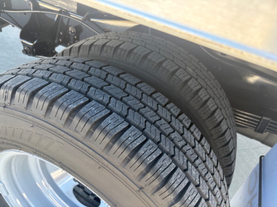 Ford E-350 box truck showing dual rear tires with tread pattern and wheel wells.