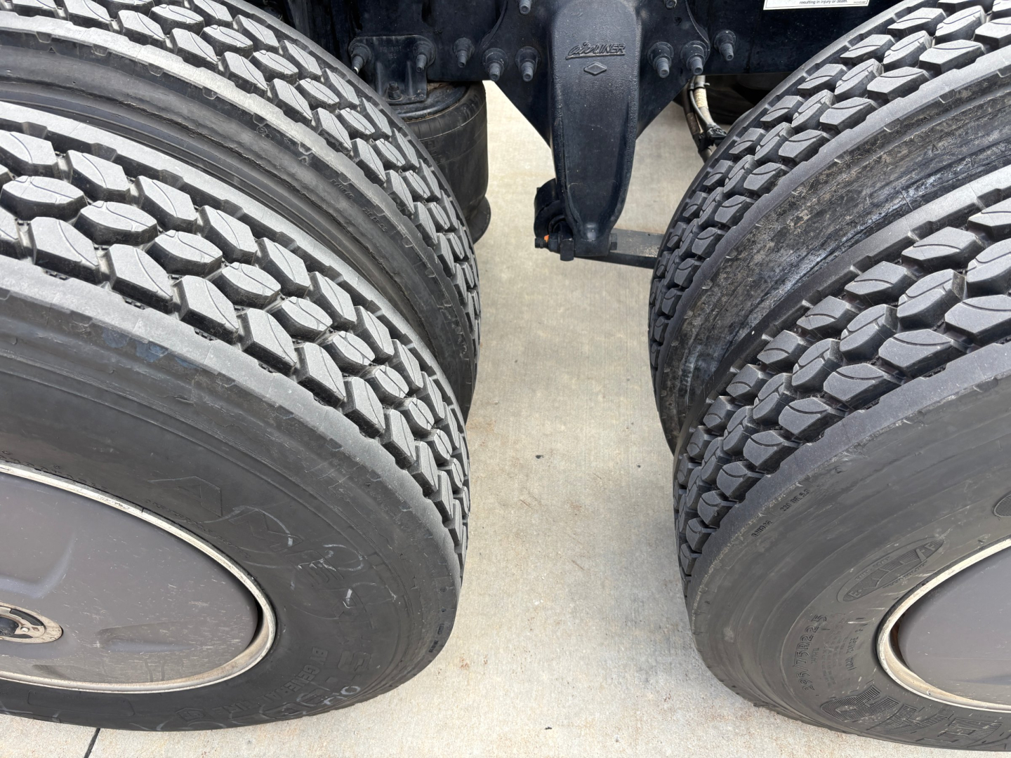 Freightliner PT126064ST truck rear view showing tandem axles and dual tires.