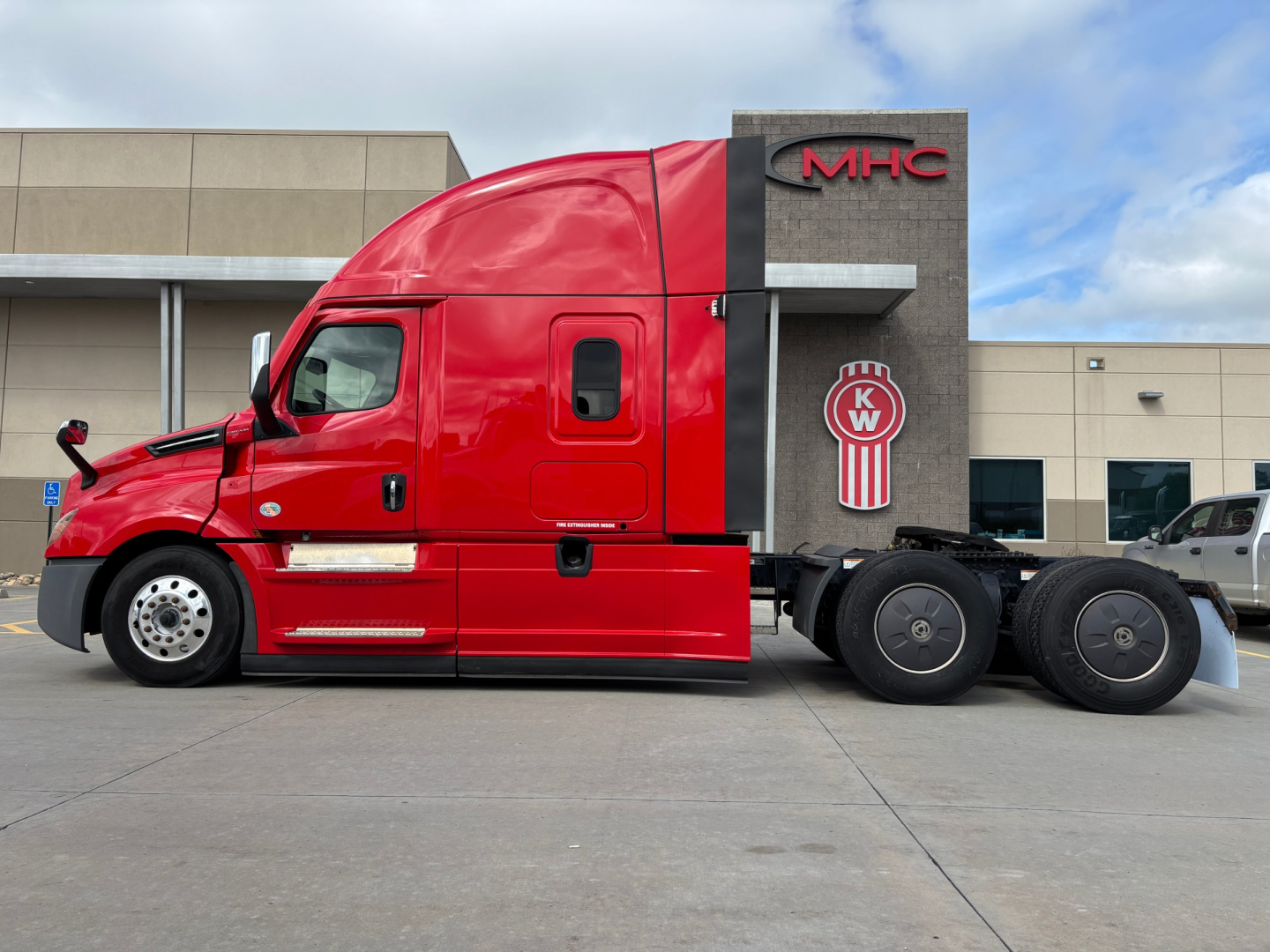 Freightliner PT126064ST sleeper cab tractor in red, side view, with chassis and rear wheels visible.