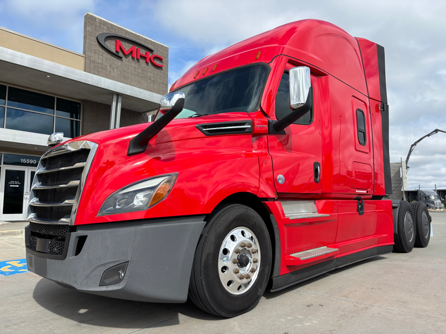 Truck cab in spotlight showing Freightliner PT126064ST model text and components.