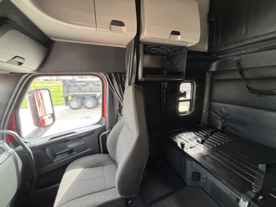 Cab interior of Freightliner PT126064ST showing sleeper area and dashboard window