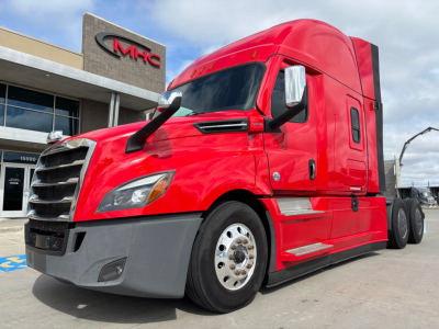 Truck cab in spotlight showing Freightliner PT126064ST model text and components.