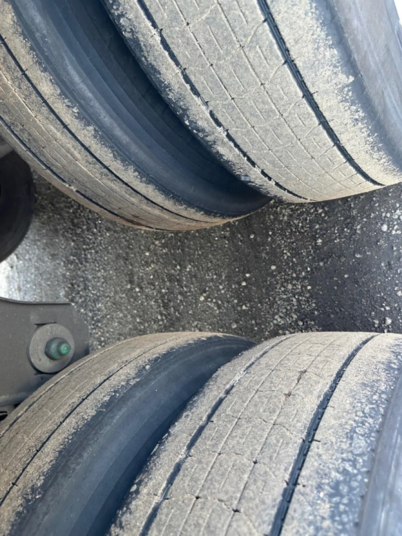 Trailer axle tires in close-up view showing tread wear and dual dual tires for a 2023 Utility S-700 trailer.