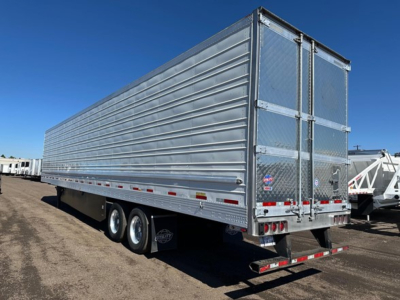 Utility S-700 trailer in a side view with ribbed metal sides and rear doors.