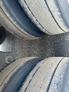 Trailer axle tires in close-up view showing tread wear and dual dual tires for a 2023 Utility S-700 trailer.