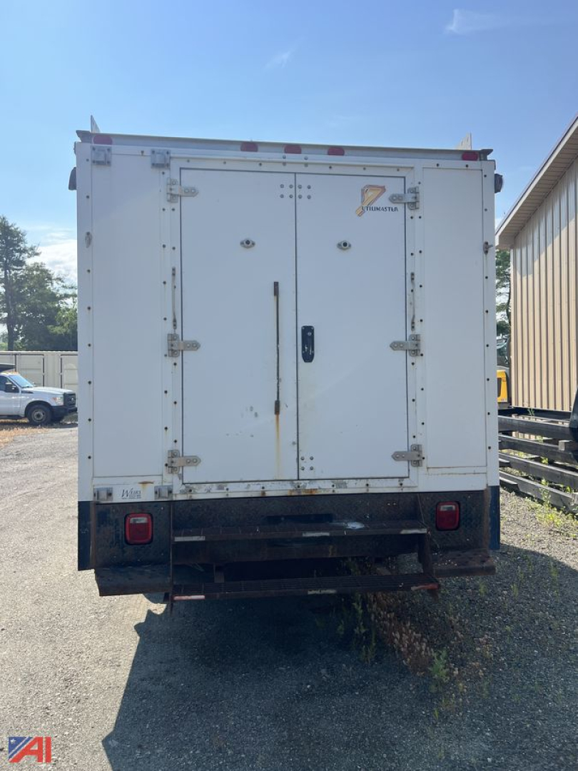 Rear view of a white 2008 GMC TopKick C4500 utility truck box with double doors and taillights.