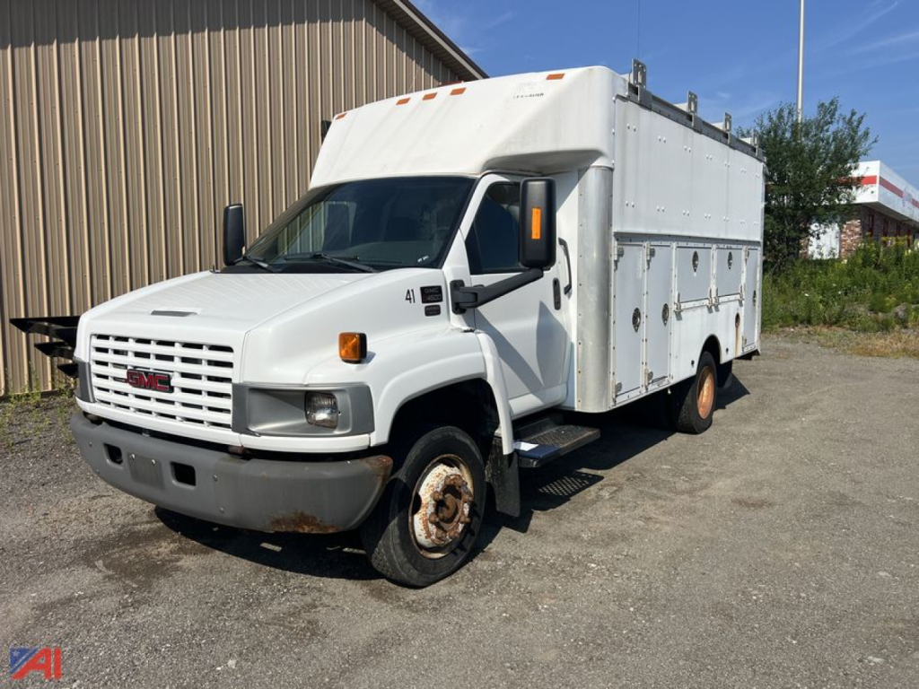 GMC TopKick C4500 utility truck in-service with white utility box, front grille and side compartments visible.