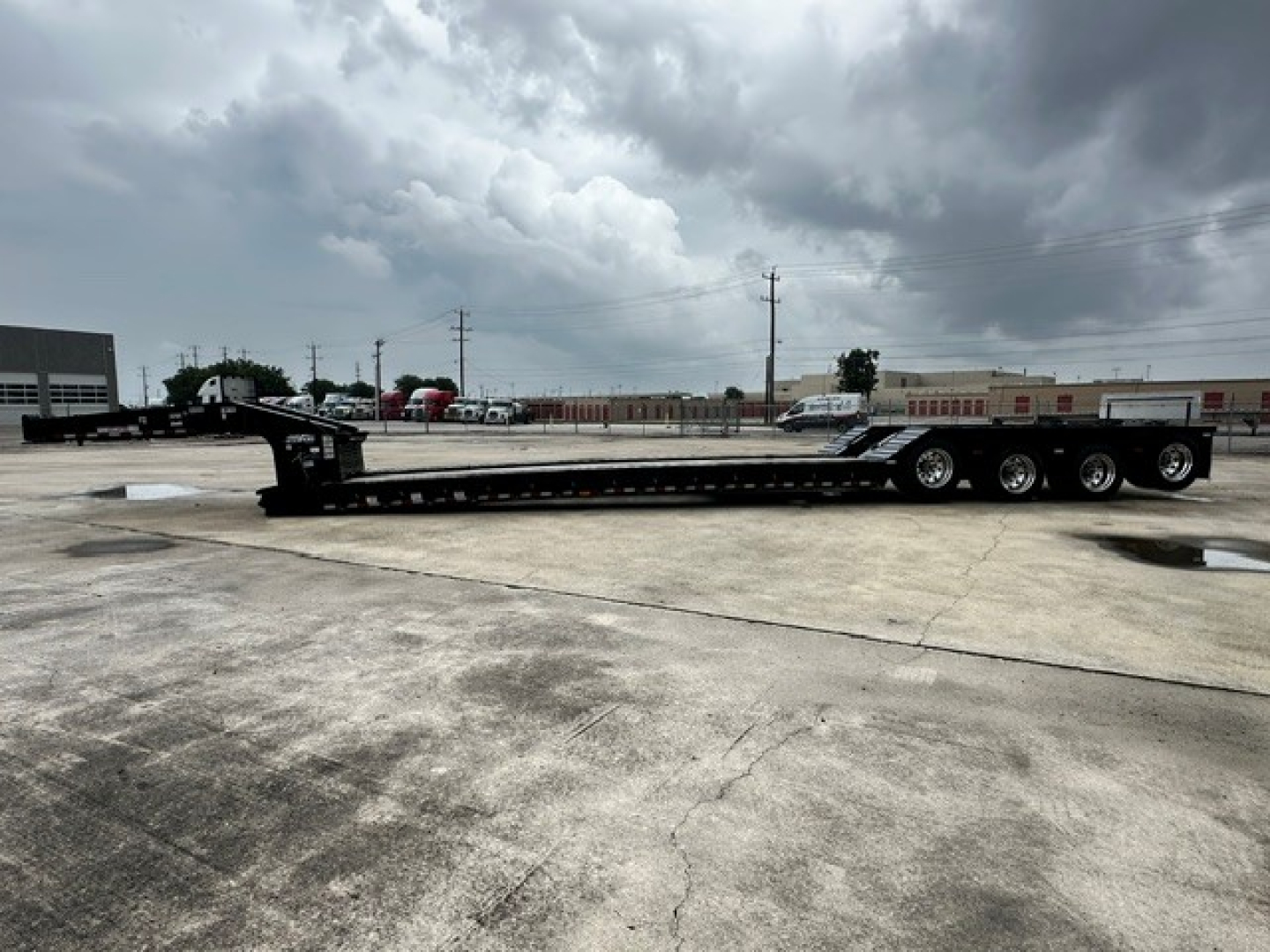 Long Load King lowboy trailer showing multiple axles and flatbed with gooseneck area; details not legible from distance.