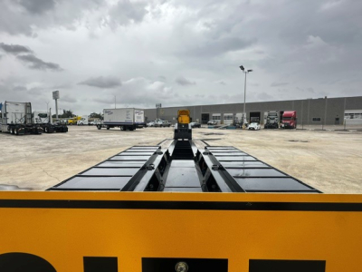 Truck trailer deck view showing Load King 604/5 lowboy trailer with yellow frame and black deck sections.