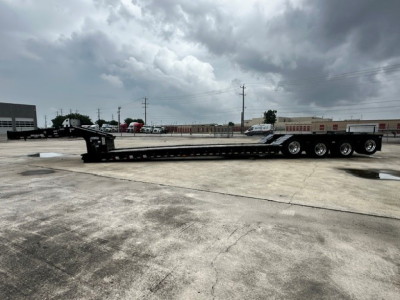 Long Load King lowboy trailer showing multiple axles and flatbed with gooseneck area; details not legible from distance.