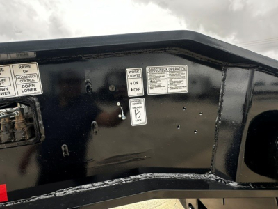 Load King trailer interior panel with labels and operation instructions showing switches and stickers.