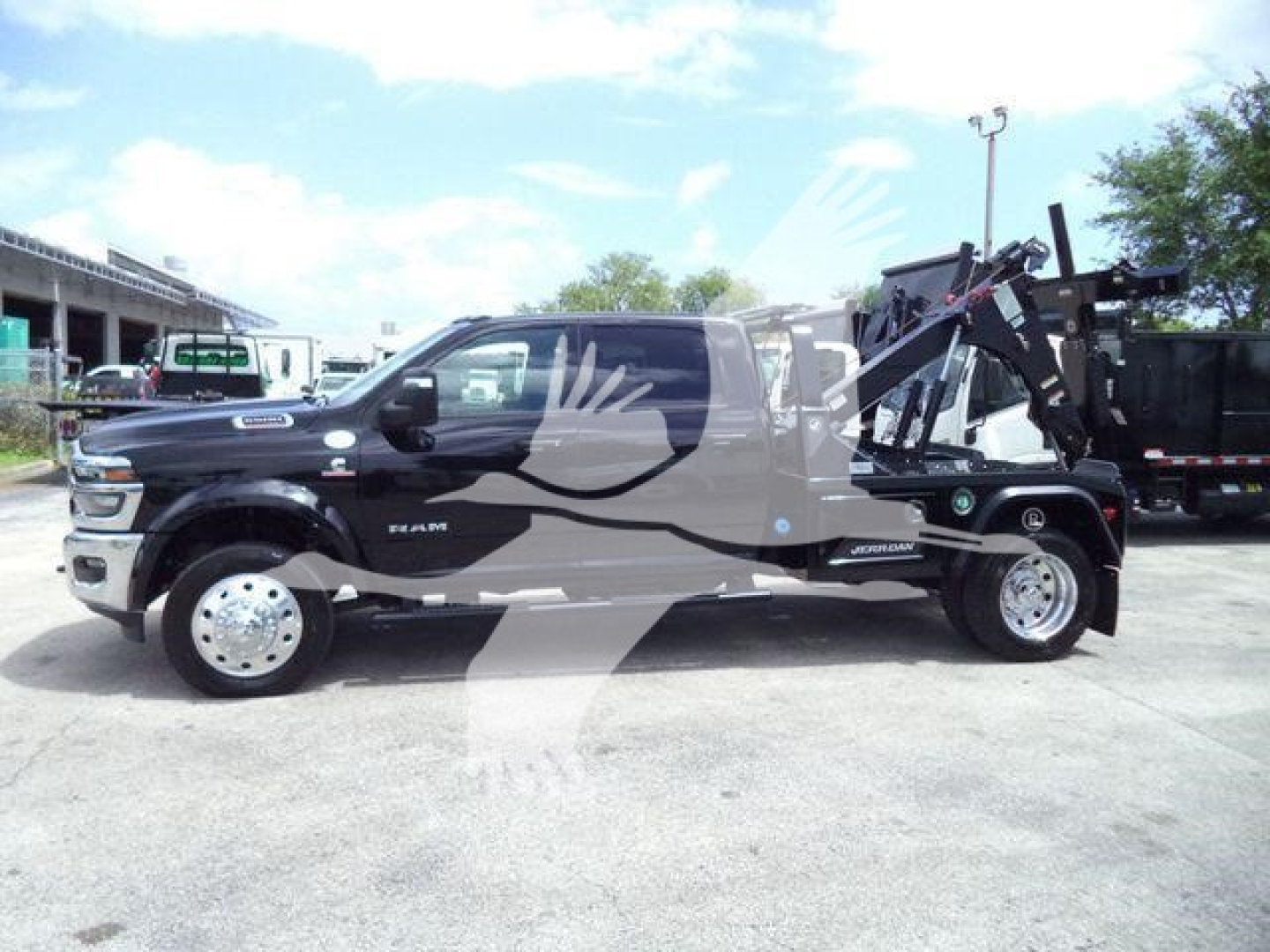 Ram 5500 Big Horn pickup with winch equipment and jeeps in background, side profile view