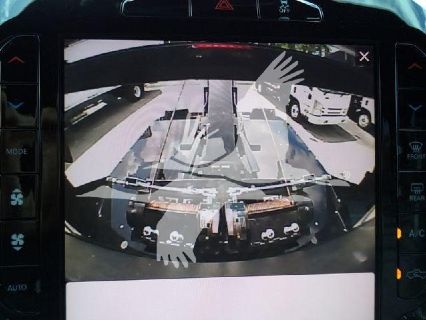 Ram 5500 engine bay with winch components visible and a rearview camera overlay.
