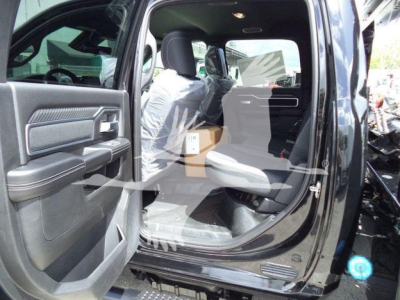 Ram 5500 Big Horn truck interior with front passenger seat and open rear door showing front and back seats and dashboard.