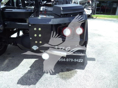 Truck rear showing winch equipment and spare light, with watermark and contact number on black metal bumper.