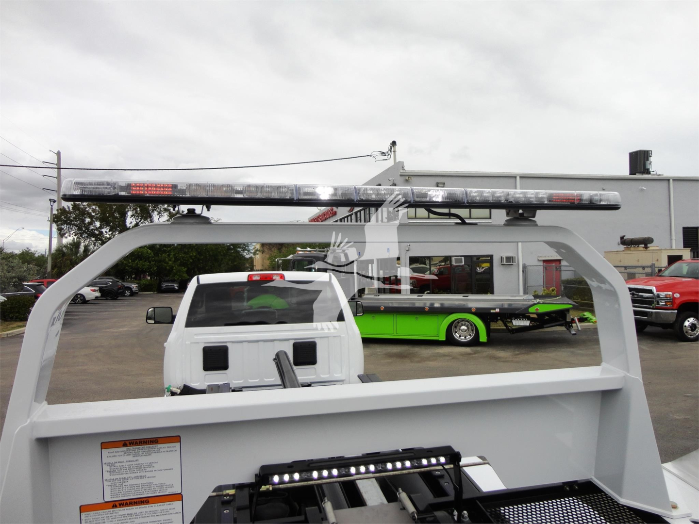 Ram 5500 rollback truck bed with light bar on top showing stock image from dealership.