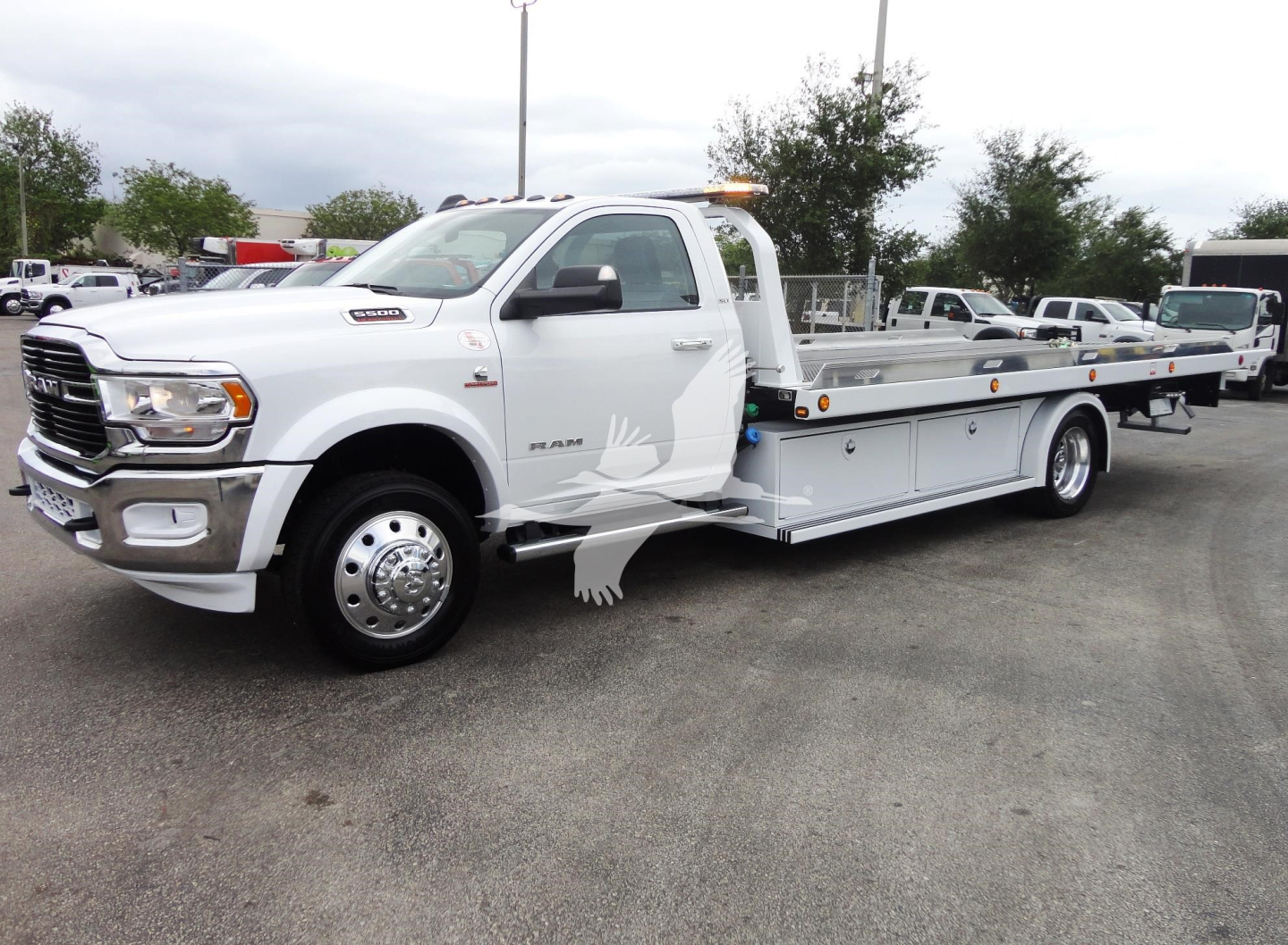 2023 Ram 5500 HD SLT tow truck profile showing rollback bed and dual rear wheels.