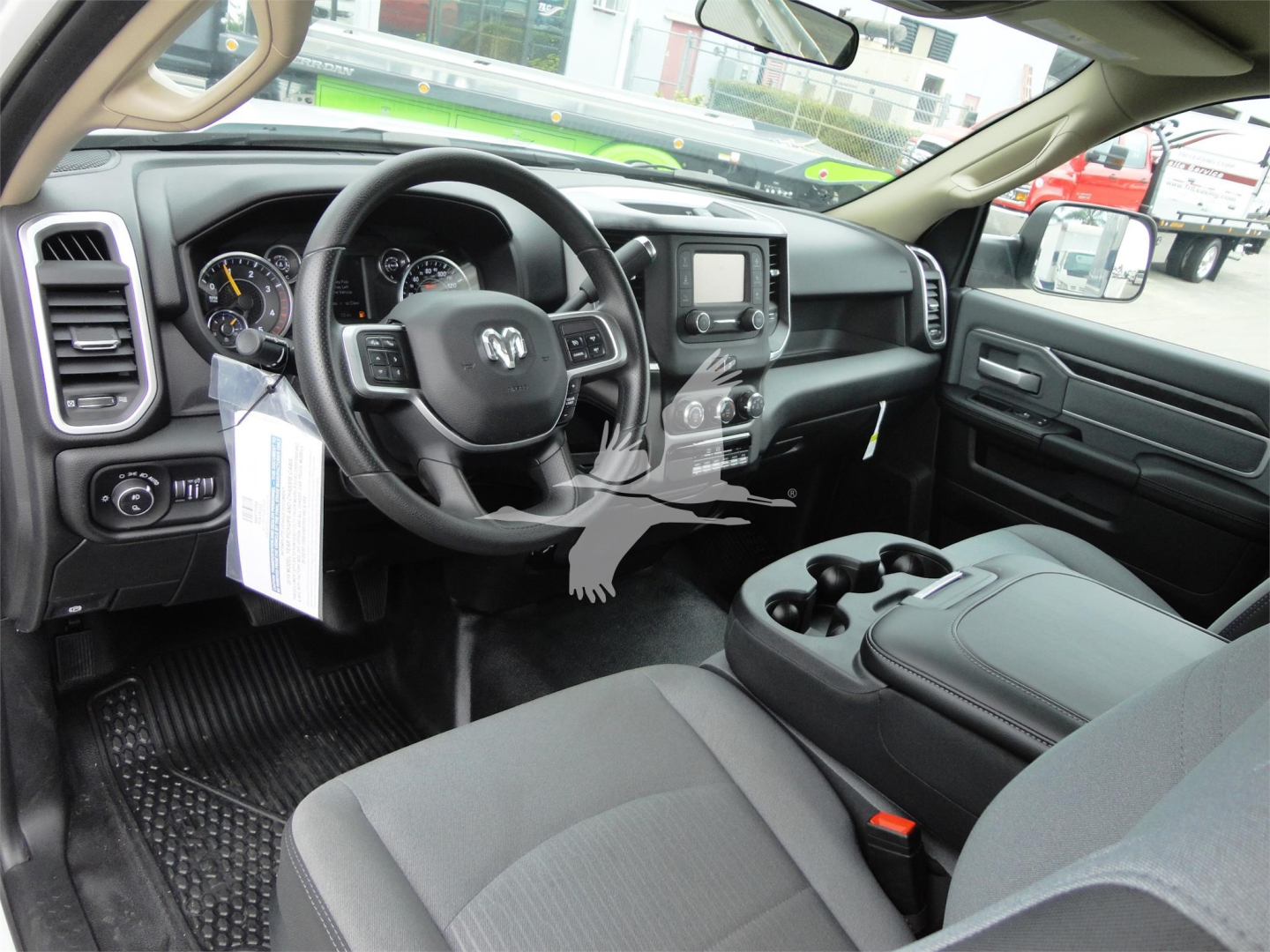 Ram 5500 HD SLT interior showing steering wheel with RAM logo, center console with touchscreen, and front seats with cup holders.