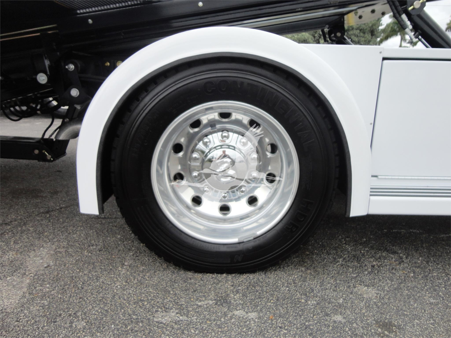 Ram 5500 wheel and fender with chrome hubcap and white body panel visible.