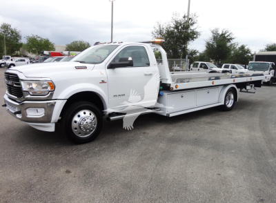 2023 Ram 5500 HD SLT tow truck profile showing rollback bed and dual rear wheels.