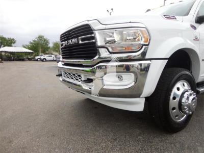 Ram 5500 front-right view showing grille, headlight, bumper, chrome trim, and wheel fender on a white pickup truck.